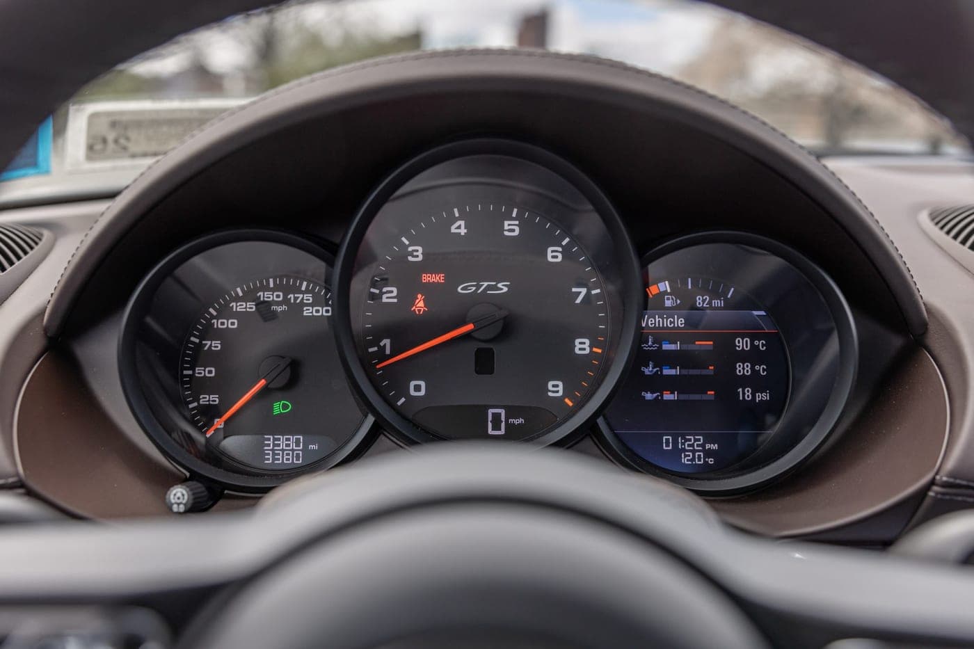 Instrument cluster of a Porsche 718 Cayman GTS 4.0 with the central tachometer and the odometer reading visible