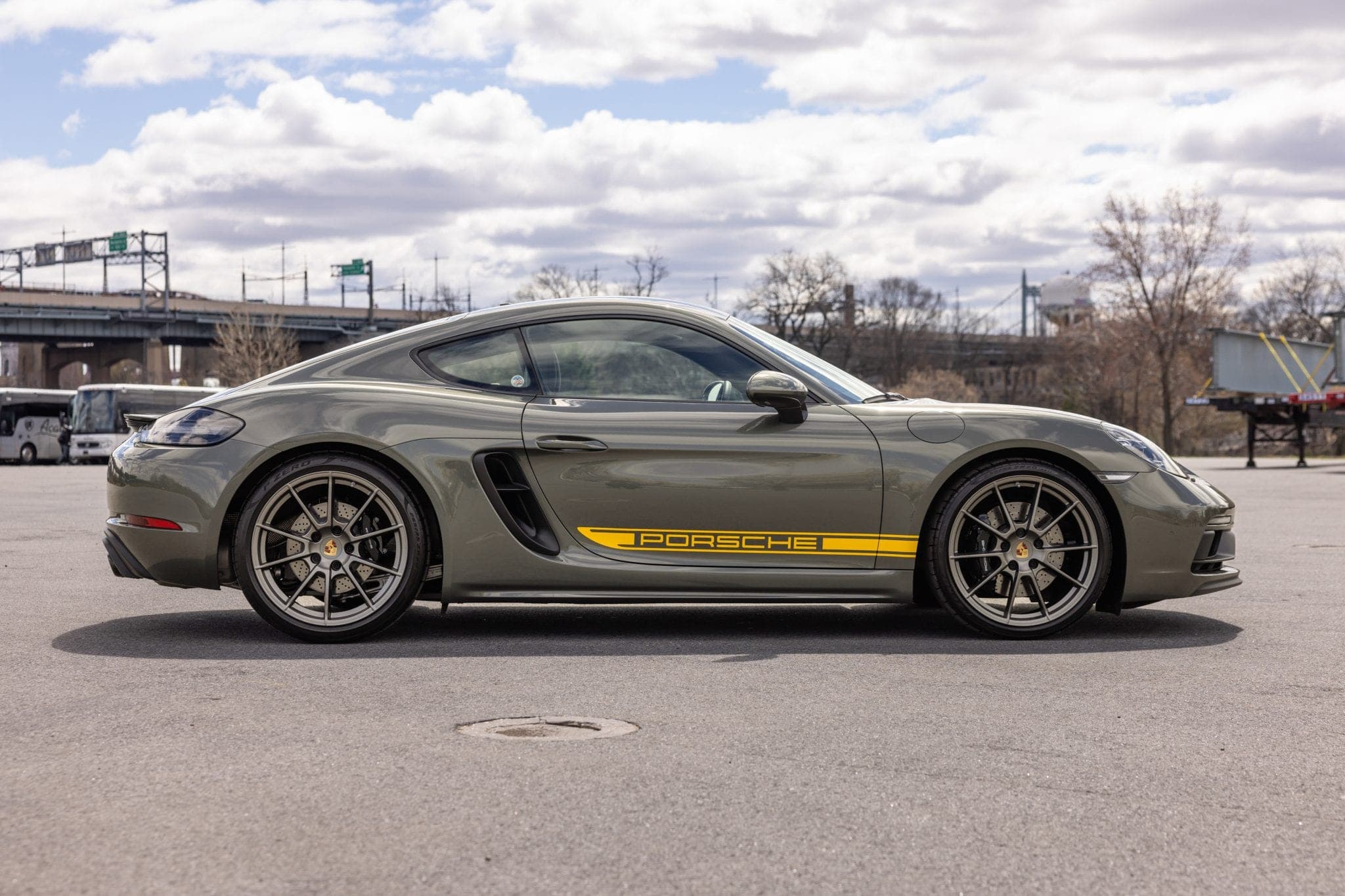 Aventurine Green Porsche 718 Cayman GTS 4.0 in side profile, showing the GTS side decal and centre-lock-style wheels