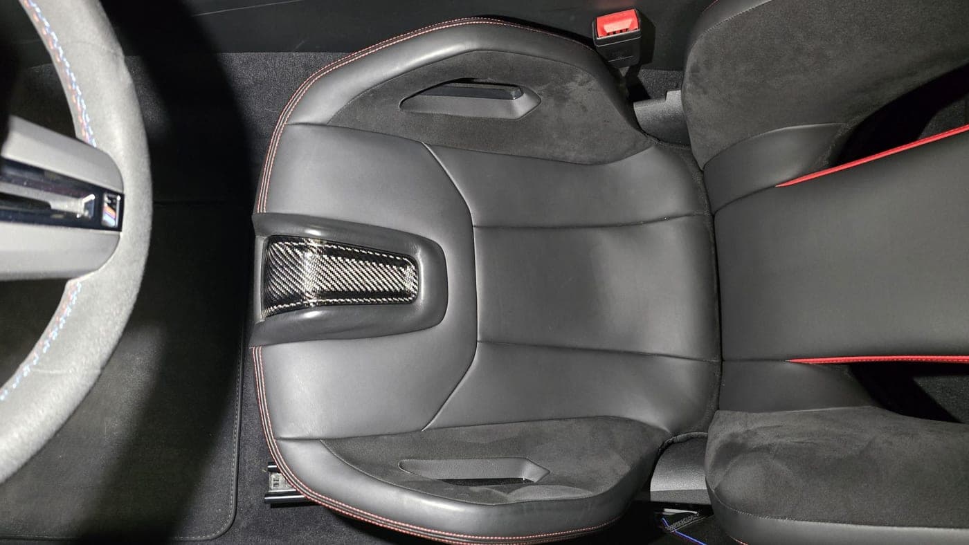 Carbon-shell bucket seat with red contrast stitching in a BMW M5 CS
