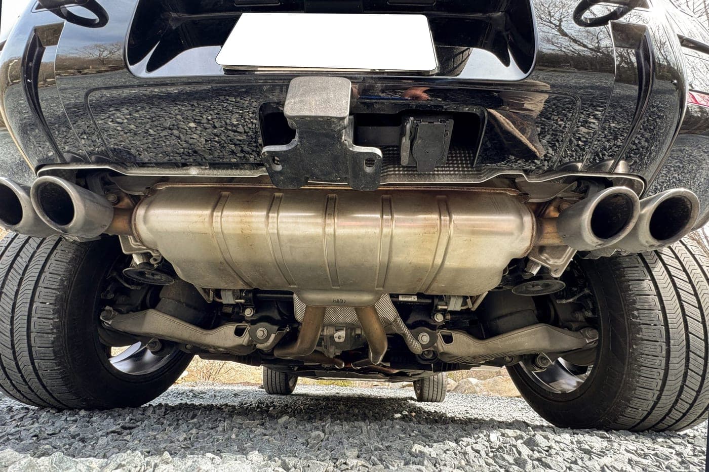 Rear underbody of a Land Rover Defender 90 showing the silencer, twin tailpipes and rear valance